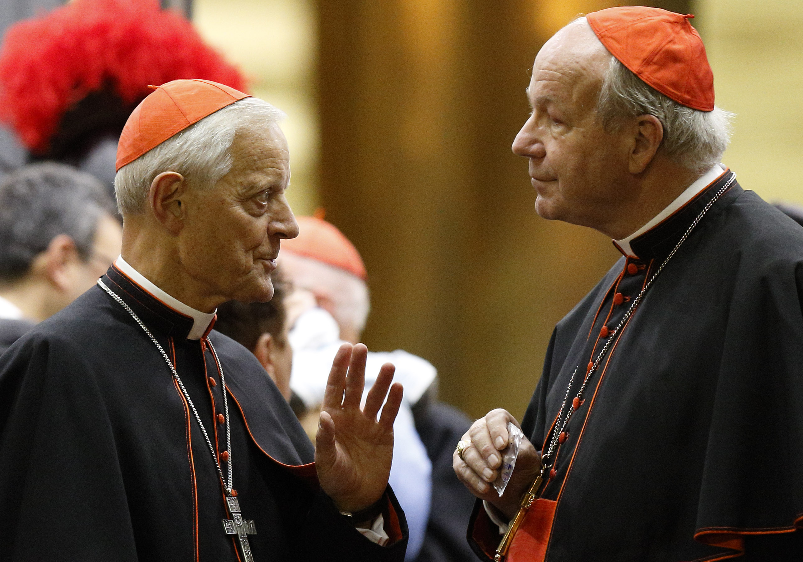 Cardinal Donald W. Wuerl of Washington, left, talks with Cardinal Christoph Schonborn of Vienna as they leave the opening session of the Synod of Bishops on the family at the Vatican Oct. 5, 2015 (CNS/Paul Haring)