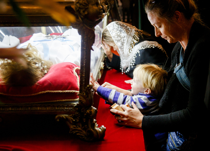 Mother helps her child touch the reliquary containing the relics of St. Maria Goretti at the Cathedral of the Holy Cross in Boston Oct. 5. The major relics, which are virtually all of the skeletal remains of the saint, known as the "patroness of purity," are on a U.S. "pilgrimage of mercy" this fall that will go to nearly 20 states. (CNS/Gregory L. Tracy)