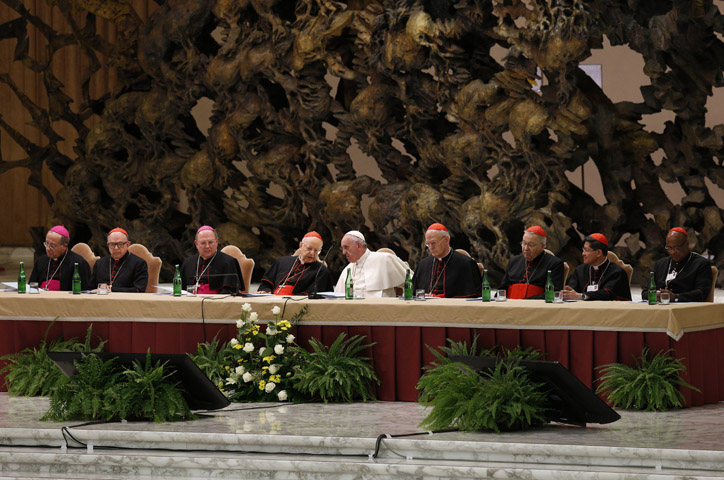 Pope Francis and leaders of the Synod of Bishops on the family and top officials from the synod's general council attend an event marking the 50th anniversary of the Synod of Bishops in Paul VI hall at the Vatican Oct. 17. The pope outlined his vision for how the entire church must be "synodal" with everyone listening to each other, learning from each other and taking responsibility for proclaiming the Gospel. (CNS/Paul Haring)