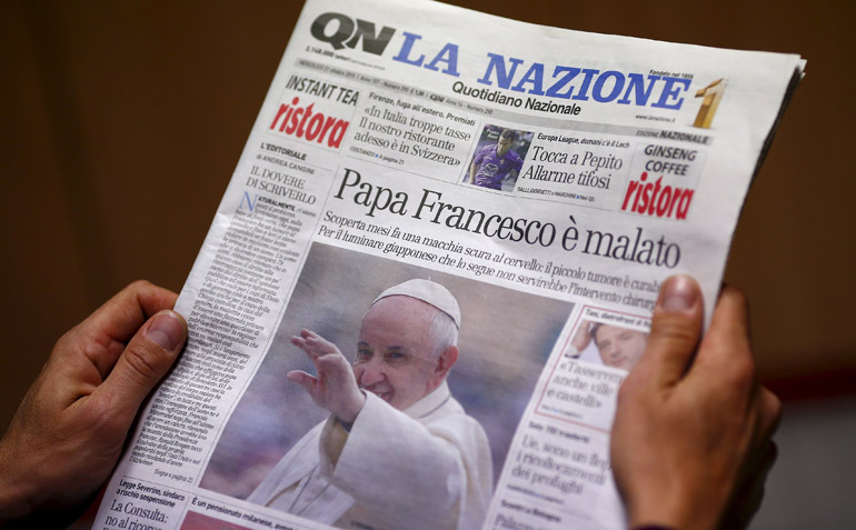Man reads Italian newspaper in Rome, Oct. 21, claiming Pope Francis has a benign brain tumor. (CNS/Tony Gentile, Reuters)