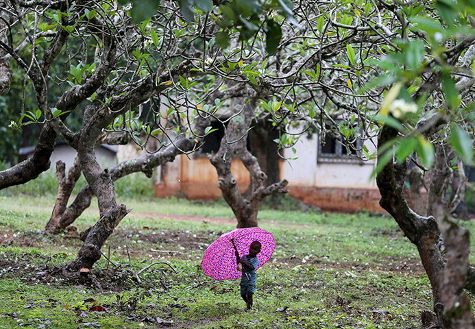 A boy walks with an umbrella during a shower in Bambari, Central African Republic, Oct. 17. Faith leaders there hope Pope Francis' November visit will help with the peace process. (CNS/Goran Tomasevic, Reuters)