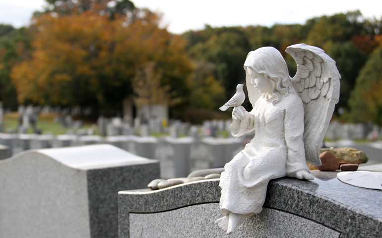An angel figurine tops a headstone Oct. 24, 2015, at St. Peter's Cemetery in the Staten Island borough of New York. (CNS/Gregory A. Shemitz)
