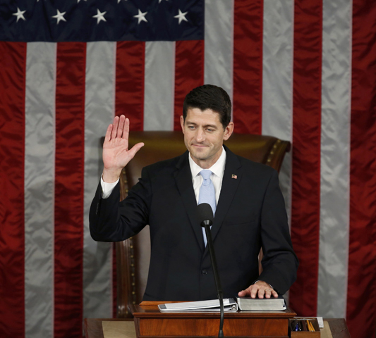 Newly elected Speaker of the U.S. House of Representatives Paul Ryan, R-Wis., raises his hand and places the other on a Bible as he is sworn in on Capitol Hill in Washington Oct. 29. He succeeds outgoing speaker, Rep. John Boehner, R-Ohio. (CNS/Gary Cameron, Reuters) 