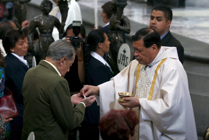 Cardinal Norberto Rivera Carrera of Mexico City distributes Communion during Mass in early May at Mexico City's Metropolitan Cathedral. Pope Francis will visit Mexico in February, marking the pontiff's first trip to the heavily Catholic country, said Cardinal Rivera. (CNS photo/Ricardo Castelan, EPA)