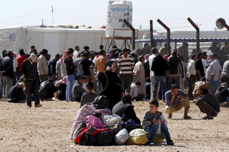 Syrians refugees at the Zaatari refugee camp Nov. 1 wait to register their names to return to their homeland in Syria. (CNS/Reuters/Muhammad Hamed)
