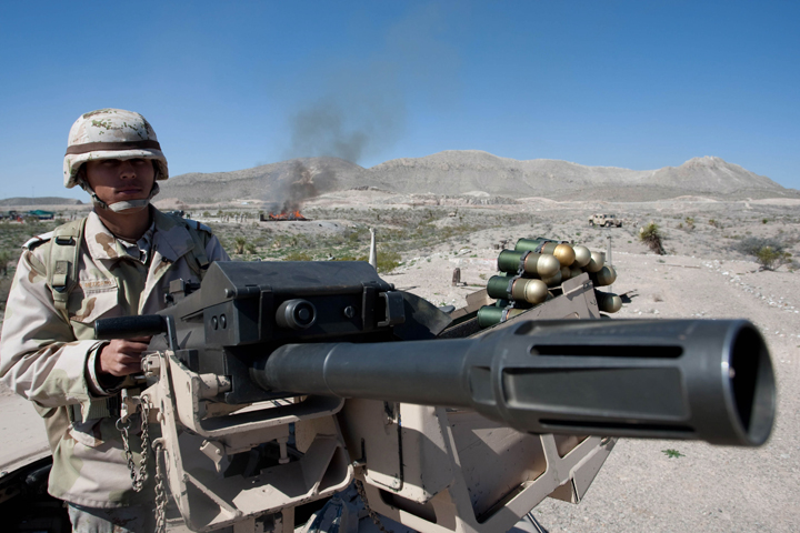 A Mexican soldier stands guard outside of Ciudad Juarez, Mexico, as soldiers burn tons of drugs in 2010. Pope Francis is exploring the possibility of visiting the previously problematic border city of Ciudad Juarez, where a battle between drug cartels during the last decade cost more than 10,000 lives in a four-year period. (CNS/Jesus Alcazar, EPA) 