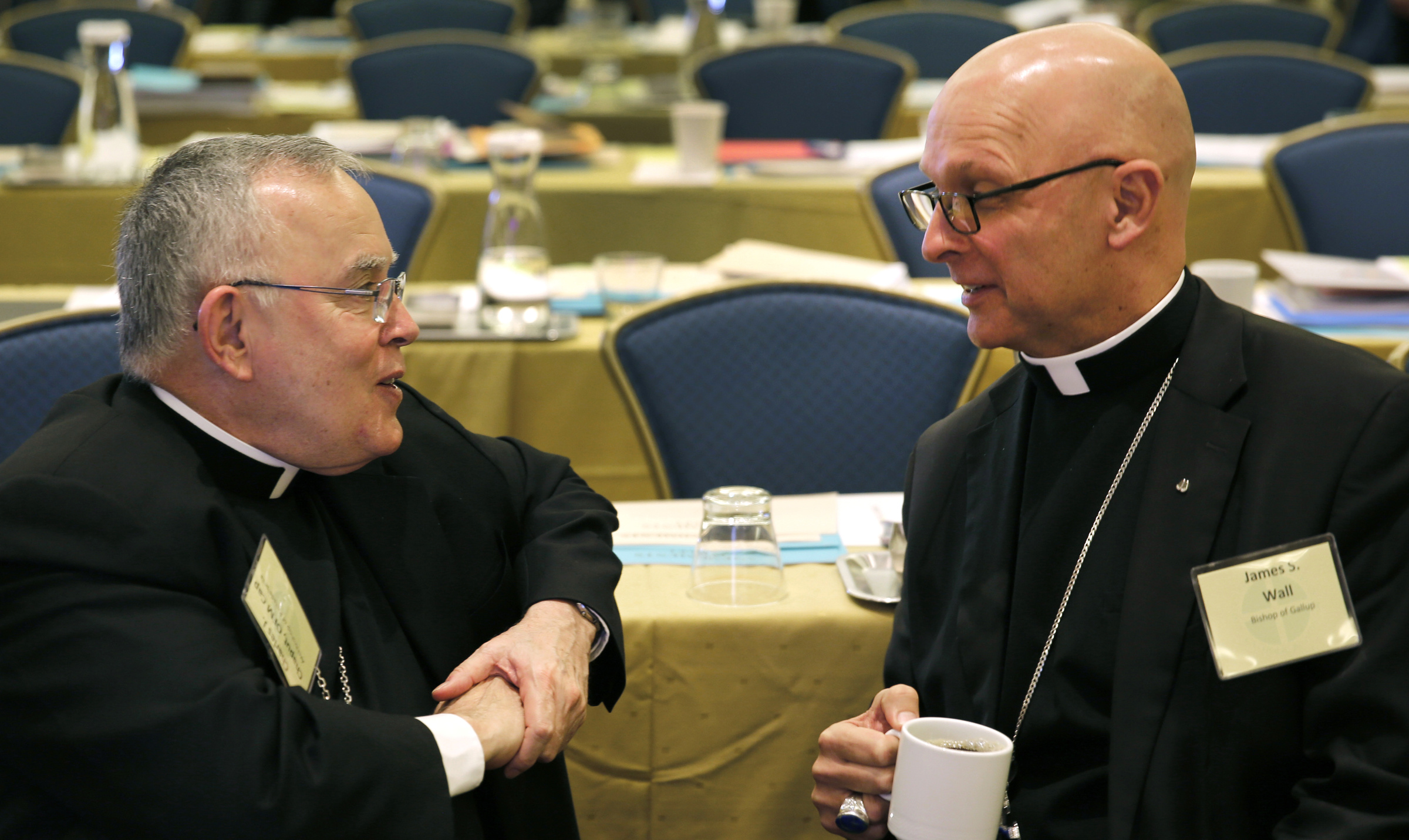 Archbishop Charles J. Chaput of Philadelphia and Bishop James S. Wall of Gallup, N.M., chat during a break at the 2015 fall general assembly of the U.S. Conference of Catholic Bishops in Baltimore Nov. 17. (CNS/Bob Roller) 