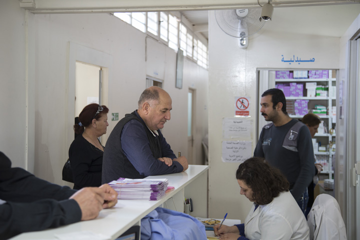 Iraqi refugee Wissam, 60, center, waits for his turn Nov. 18 at St. Anthony’s medical dispensary in Beirut. The clinic, run by the Good Shepherd Sisters, functions as a primary health care center, serving Iraqi and Syrian refugees, as well as Lebanon's poor. (CNS/Dalia Khamissy) 