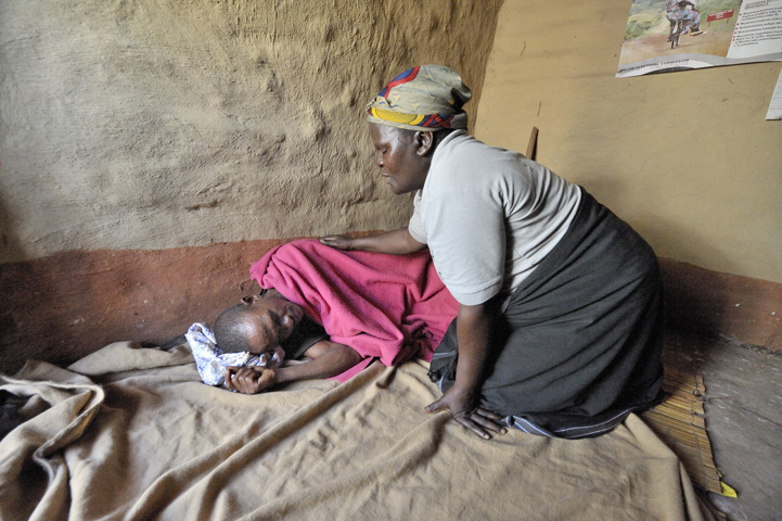 Home-based care worker Olipa Mkandawire prays for a man living with AIDS in Matuli, Malawi, in this 2009 photo. (CNS/Paul Jeffrey)