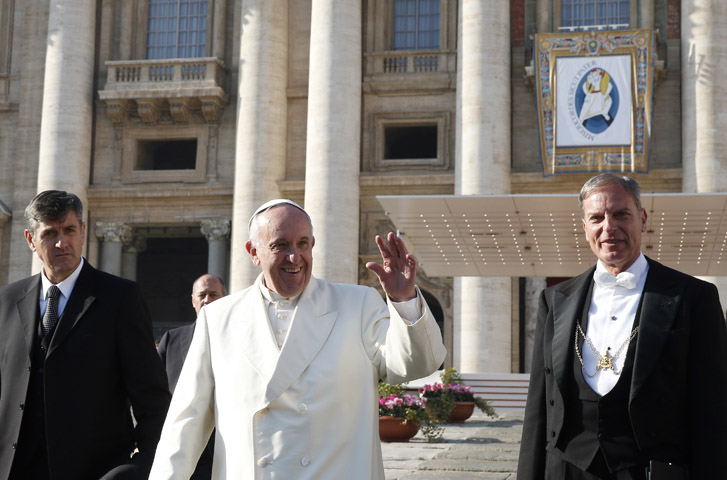 Pope Francis waves as he leaves his general audience in St. Peter's Square at the Vatican Dec. 9. (CNS/Paul Haring)