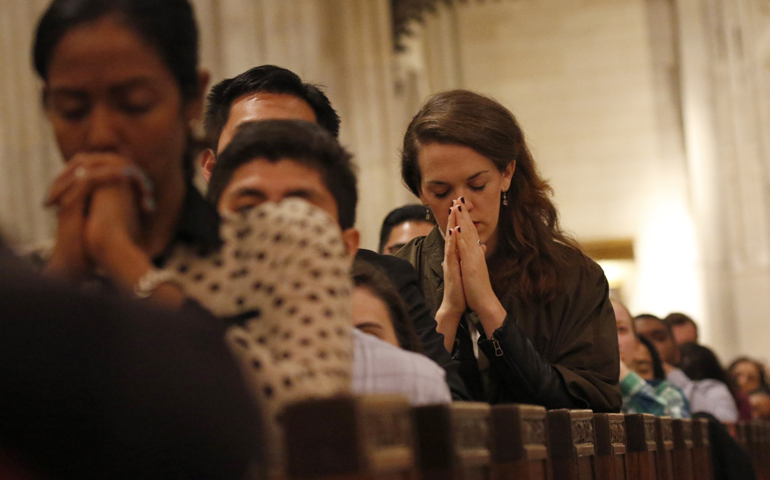 Young adults pray during eucharistic adoration at St. Patrick's Cathedral in New York City in a 2015 file photo (CNS/Gregory A. Shemitz)