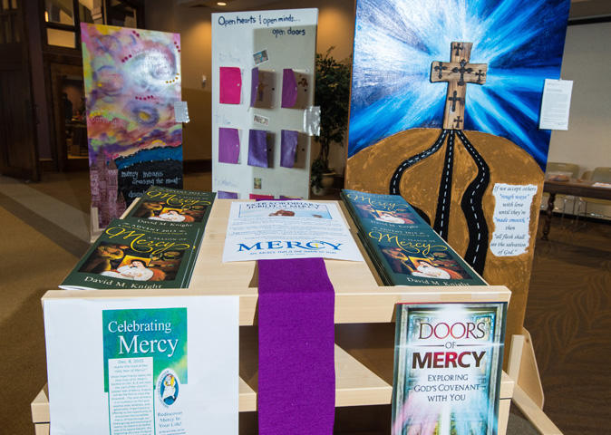 A table in the gathering space Dec. 12 at Prince of Peace Church in Bellevue, Wis., offers materials on the topic of mercy. (CNS/Sam Lucero, The Compass)
