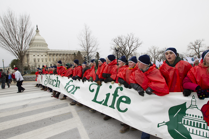 Young people walk with a banner past the U.S. Capitol in 2012 during the annual March for Life in Washington. (CNS/Bob Roller) 