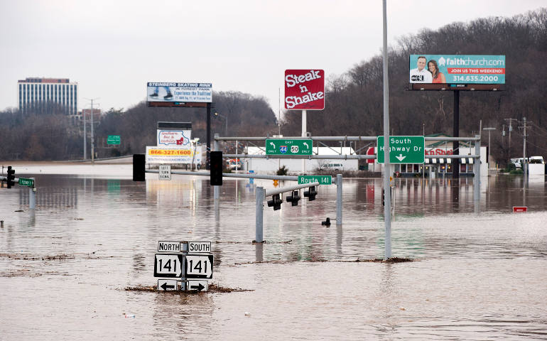 Floodwaters from the nearby Meramec River fill the traffic lanes of I-44 and Missouri Route 141 Dec. 30 in Valley Park, just outside St. Louis. (CNS/Sid Hastings, EPA)