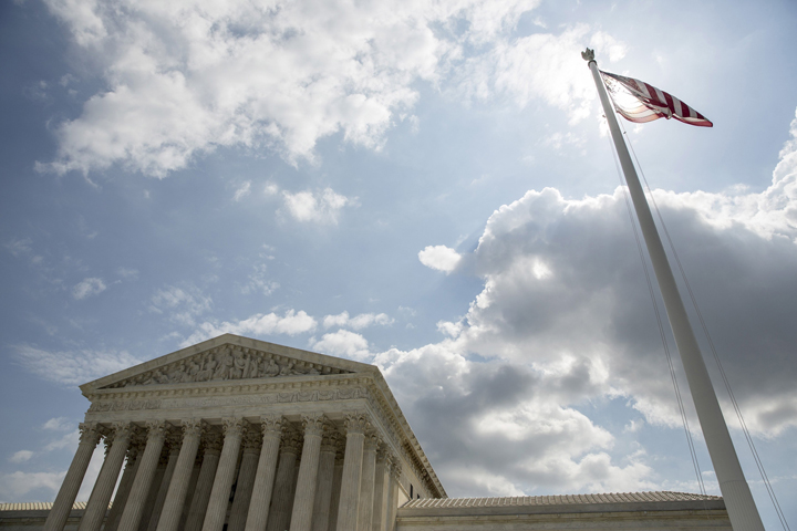 The U.S. flag flies in front of the Supreme Court in Washington in this file photo from May 18, 2015. (CNS/Joshua Roberts, Reuters)