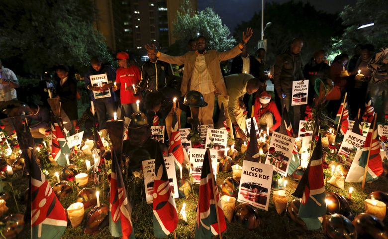 A man prays with others during a candlelight vigil in Nairobi, Kenya, Jan. 21 for soldiers killed while serving in the African Union Mission in Somalia. (CNS/Thomas Mukoya, Reuters) 