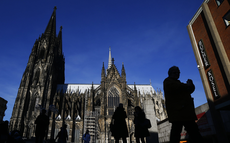 People are silhouetted against the Cologne Cathedral in Germany Jan. 25, 2016. (CNS Photo/Wolfgang Rattay, Reuters)