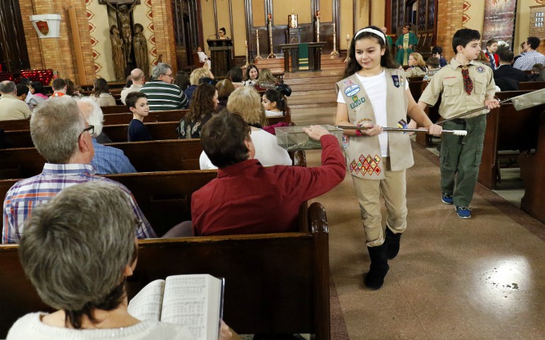 Girl Scout Julia Ocasio, 13, and Boy Scout Thomas Perotta, 10, use collection baskets during a Scout Sunday Mass Feb. 7 at Immaculate Heart of Mary Church in the Windsor Terrace neighborhood of the New York borough of Brooklyn. (CNS photo/Gregory A. Shemitz)