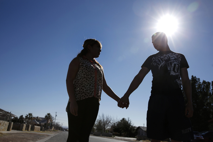 Thalia Hernandez and her boyfriend, Rafael Muriel, stand on a street Feb. 15 in the El Paso, Texas, neighborhood where they live. Hernandez at age 17 had fled her home in Mexico out of fear for her life and came to the U.S. (CNS/Nancy Wiechec)
