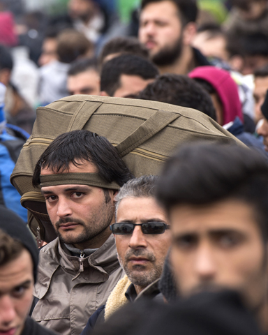 Refugees and migrants from Iraq and Syria wait for permission to leave a registration and transit camp near Gevgelija, Macedonia, Feb. 24. (CNS/Georgi Licovski, EPA)