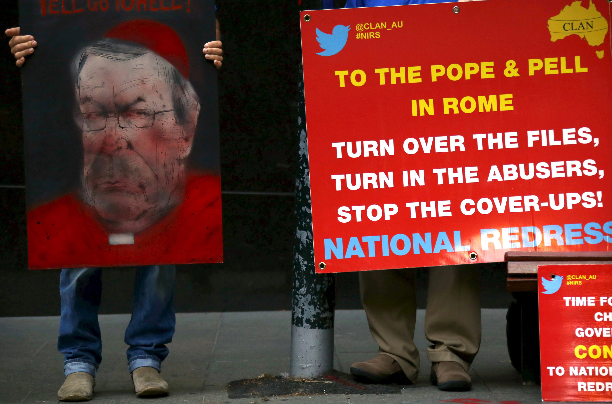 Victims and relatives of children who claim they were sexually abused by the Catholic clergy hold placards outside the venue for Australia's Royal Commission Into Institutional Response to Child Sexual Abuse in Sydney Feb. 29. (CNS/David Gray, Reuters)