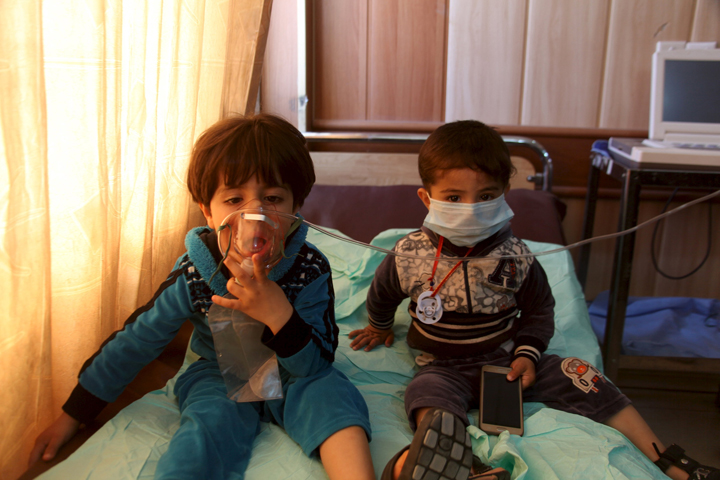 Children receive oxygen at a hospital in Taza, Iraq, March 9, after Islamic State militants fired mortar shells and rockets filled with "poisonous substances" into their village. (CNS/Stringer, Reuters)