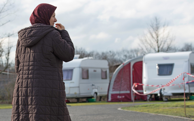 A refugee woman walks through the caravan park in Frankfurt, Germany, Feb. 12. (CNS/Alexander Heinl, EPA)