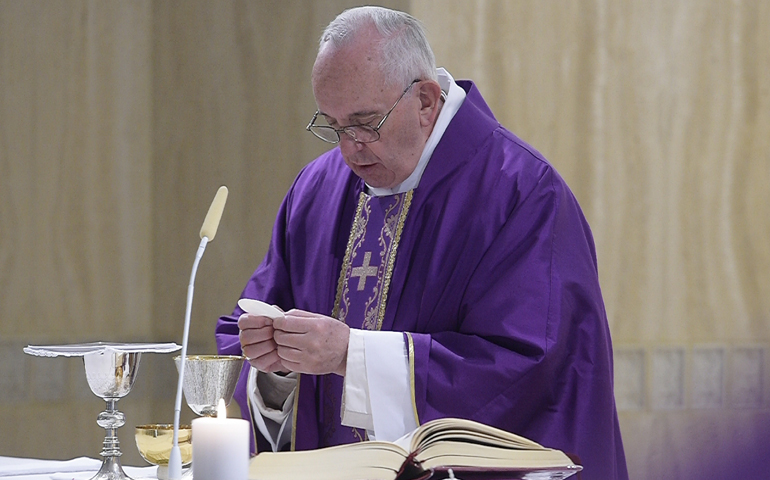 Pope Francis consecrates the Eucharist during morning Mass in the chapel of his residence at the Domus Sanctae Marthae at the Vatican March 14. (CNS photo/L'Osservatore Romano, handout)