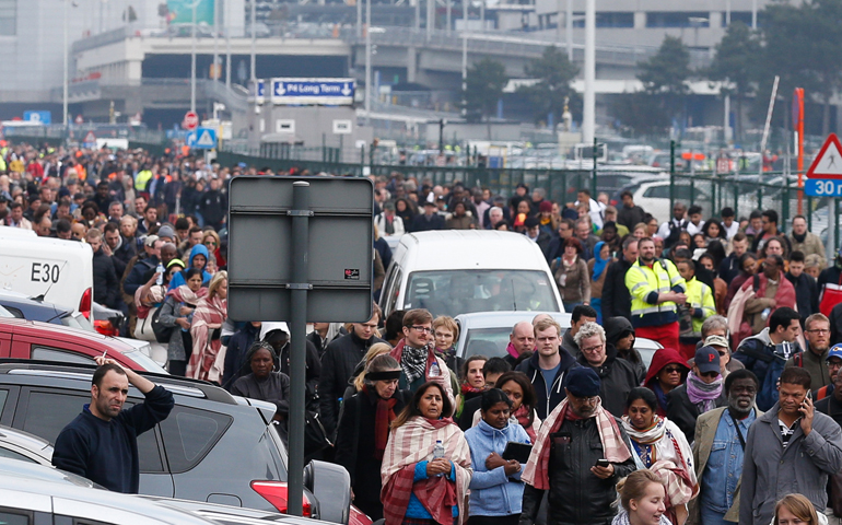 People evacuate Zaventem airport after explosions near Brussels March 22. (CNS/Laurent Dubrule, EPA)