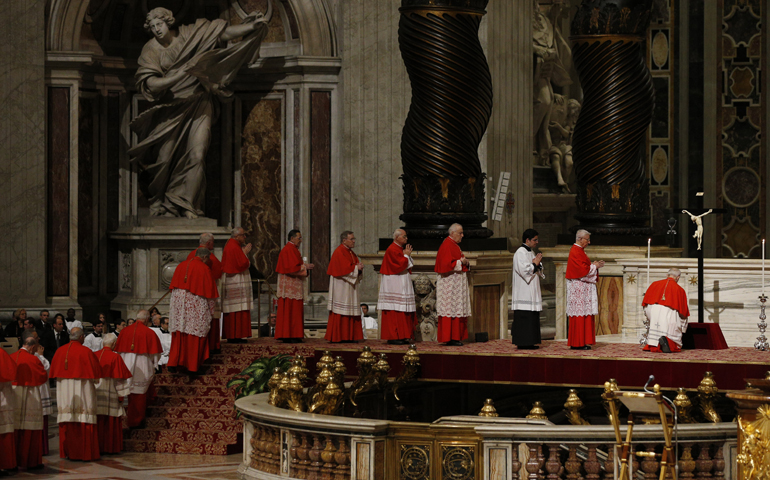 Cardinals reverence a crucifix as Pope Francis leads the Good Friday service in St. Peter's Basilica at the Vatican March 25. (CNS/Paul Haring)