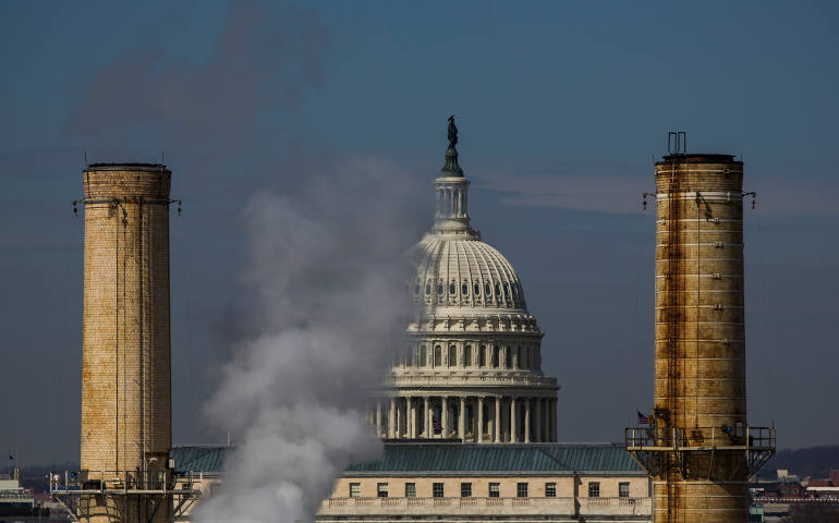 The dome of the U.S. Capitol is seen behind the smokestacks of the only coal-burning power plant in Washington in this March 10, 2014, file photo. (CNS photo/Jim Lo Scalzo, EPA)