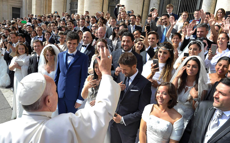 Pope Francis greets newly married couples during his general audience in St. Peter's Square at the Vatican in this Sept. 30, 2015, file photo. (CNS/L'Osservatore Romano) 