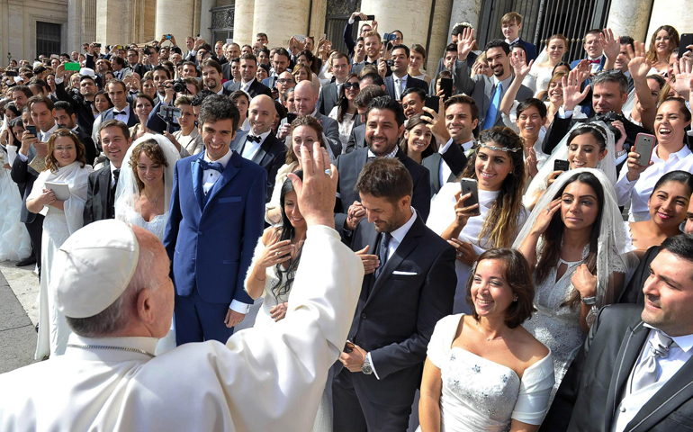 Pope Francis greets newly married couples during his general audience in St. Peter's Square at the Vatican in this Sept. 30, 2015, file photo. (CNS/L'Osservatore Romano)