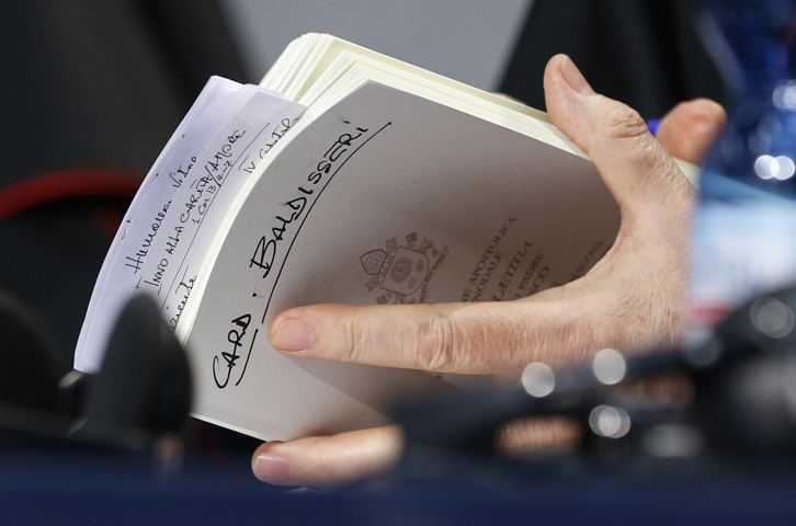 Cardinal Lorenzo Baldisseri holds his copy of "Amoris Laetitia" during a news conference for the release of the document at the Vatican April 8. (CNS/Paul Haring)