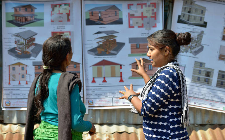 A volunteer in Makaising, Nepal, describes new construction options March 9. April 25 marks the one-year anniversary of the magnitude-7.8 earthquake that struck the Himalayan nation, killing more than 9,000 people. (CNS photo/Paul Jeffrey)