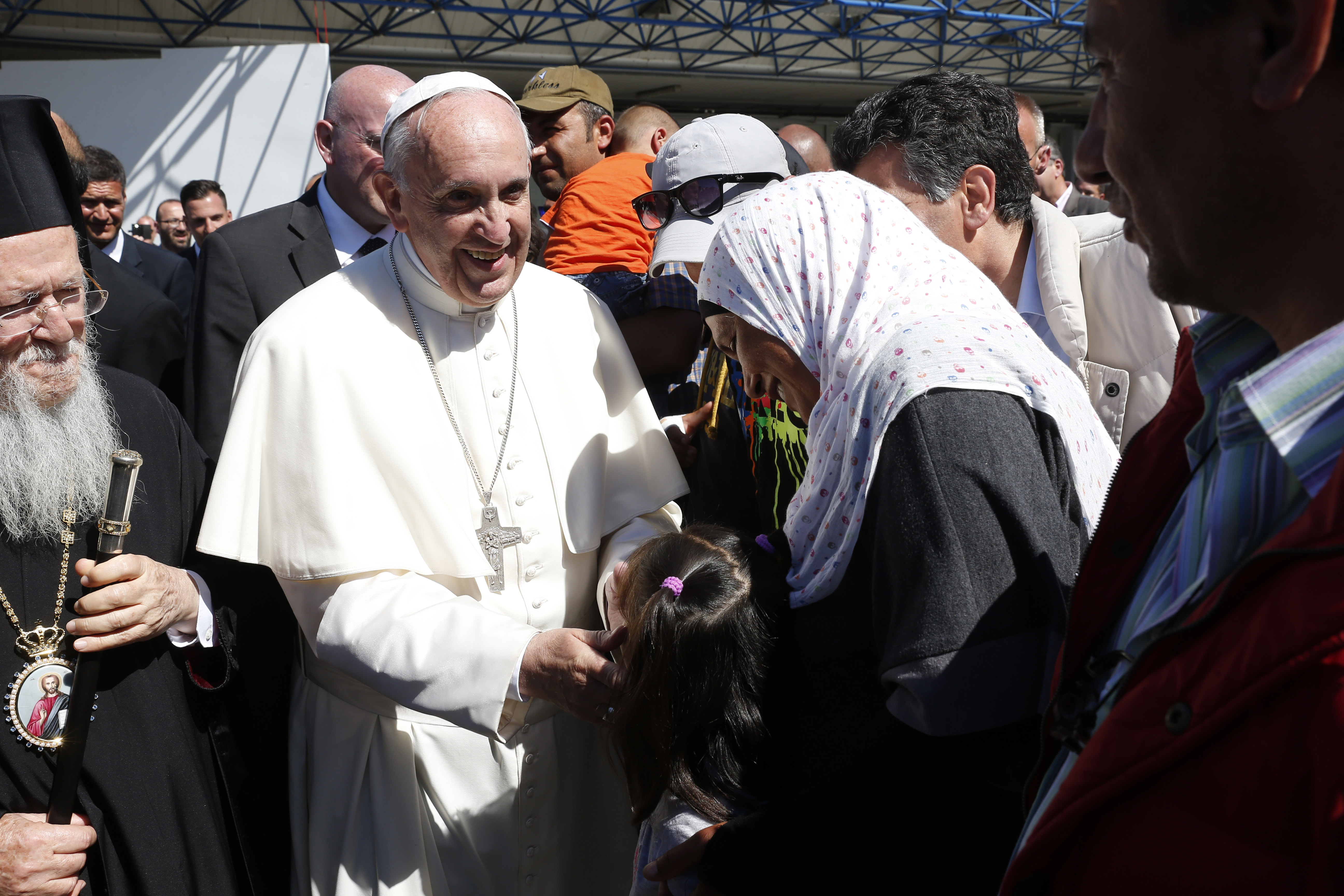 Pope Francis greets refugees who are traveling to Rome with him at the international airport in Mytilene on the island of Lesbos, Greece, April 16, 2016. The pope brought 12 refugees to Italy on his plane. (CNS/Paul Haring)