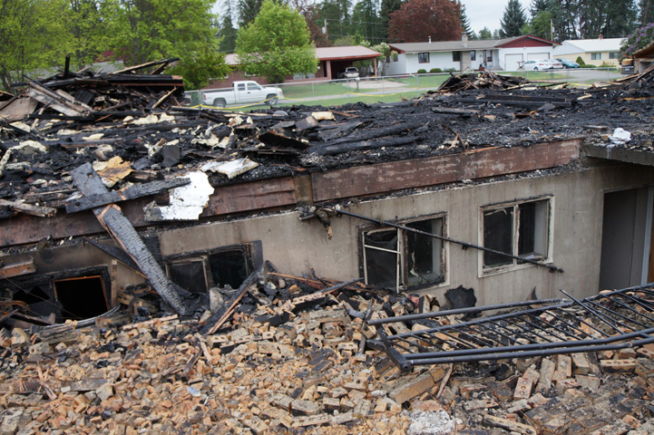 Debris surrounds the destroyed St. Ann's Church April 23 in Bonners Ferry, Idaho, after a fire, believed to have been started by vandals, ripped through the building in the early hours of April 21. (CNS/Alayna Youngwirth, Idaho Catholic Register)
