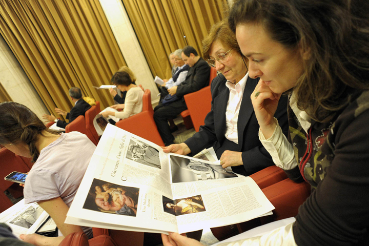 Women look at a new monthly women's insert called "Women-Church-World" in the Vatican's L'Osservatore Romano newspaper during a news conference at the Vatican in this May 30, 2012, file photo. (CNS/L'Osservatore Romano via Reuters)