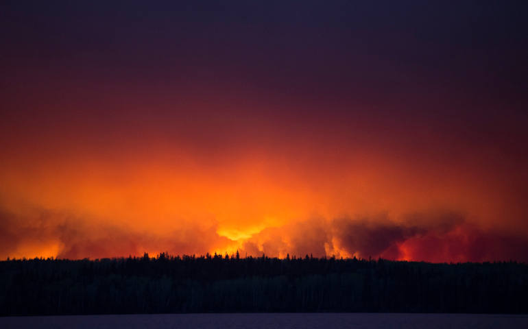A handout photo provided by the Government of Alberta shows a massive wildfire raging near Fort McMurray, Alberta. The entire population of Fort McMurray has been evacuated because of the wildfire. (CNS photo/Chris Schwarz, Government of Alberta via EPA)