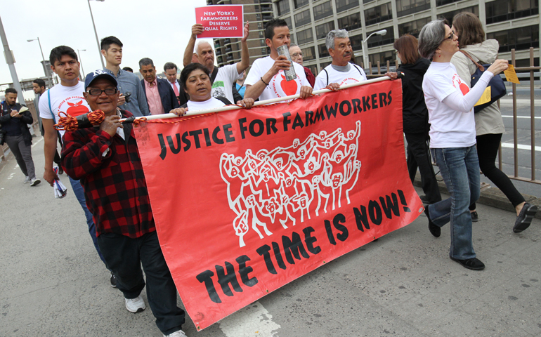 Participants in the March for Farmworker Justice cross the Brooklyn Bridge into the New York borough of Manhattan May 21. The 200-mile march aimed to draw support for legislative action guaranteeing basic labor rights for state farmworkers. (CNS/Gregory A. Shemitz)