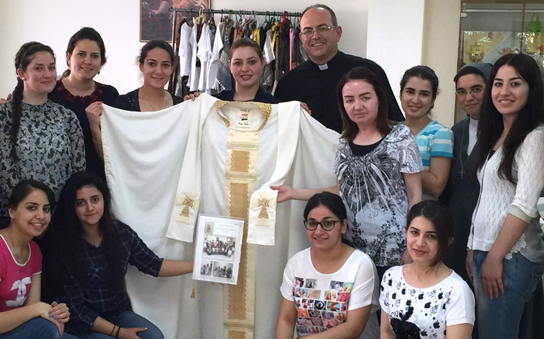 Iraqi refugee women who fled Islamic State group violence in their homeland pose for a photo in Amman, Jordan, in early June. The Chaldean Catholic women sent the hand-sewn chasuble to Pope Francis and asked him to pray for them and for peace in their country. (CNS/Catholic Center for Studies and Media in Amman)