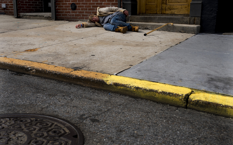 A person sleeps on a sidewalk in New York City Aug. 11, 2015. (CNS/Justin Lane, EPA)