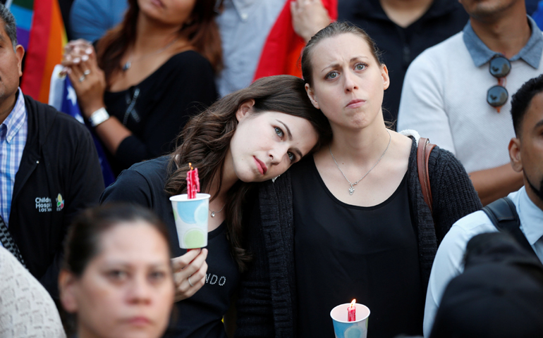 Women hold candles during a June 13 vigil in Los Angeles for the victims of the mass shooting at the Pulse gay nightclub in Orlando, Fla. (CNS/Lucy Nicholson, Reuters)