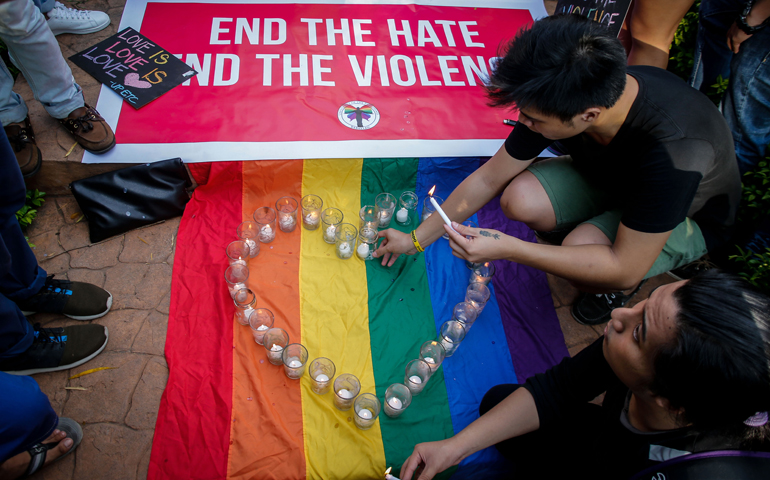 People gather at a June 14 candlelight vigil in Manila, Philippines, in memory of the victims of the mass shooting at a gay nightclub in Orlando, Fla. (CNS/Mark R. Cristino, EPA)