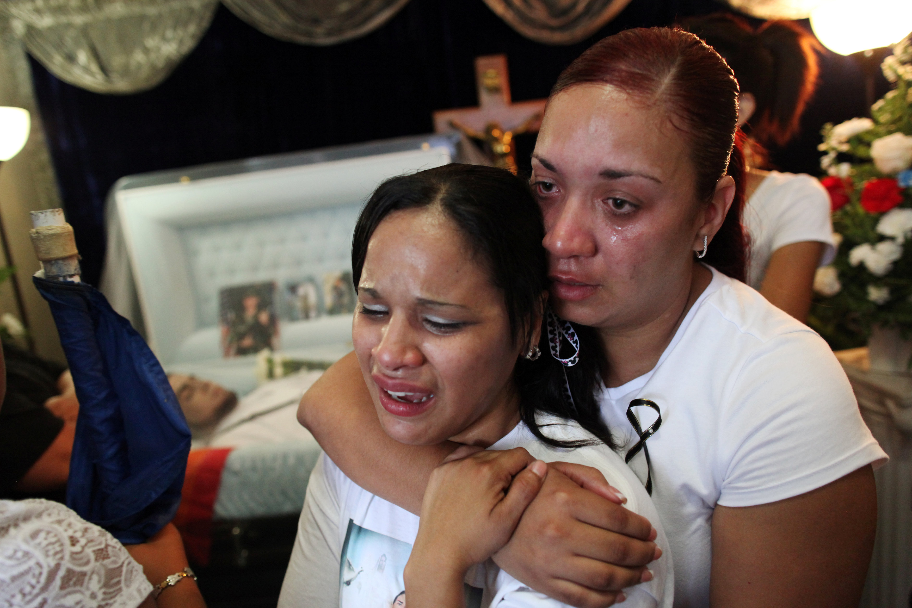 Women cry near the body of Angel Candelairo Padro during his wake June 17 in his hometown of Guanica, Puerto Rico. Candelario was of the victims of the June 12 mass shooting at the Pulse nightclub in Orlando, Fla. (CNS/Alvin Baez, Reuters)