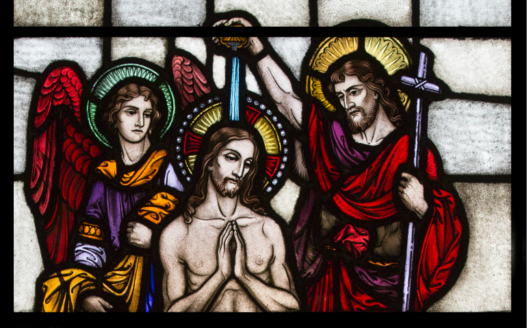 A depiction of St. John the Baptist baptizing Jesus on the Jordan River is seen in a stained-glass window in late March at St. Paul Church in Wilmington, Del. (CNS photo/Octavio Duran)