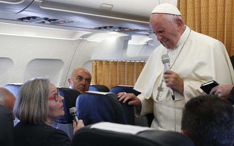Pope Francis closes his eyes as he reacts to a mention of the June 12 massacre in Orlando, Fla., from Cindy Wooden, Catholic News Service Rome bureau chief, aboard his flight from Yerevan, Armenia, to Rome June 26. (CNS/Paul Haring)