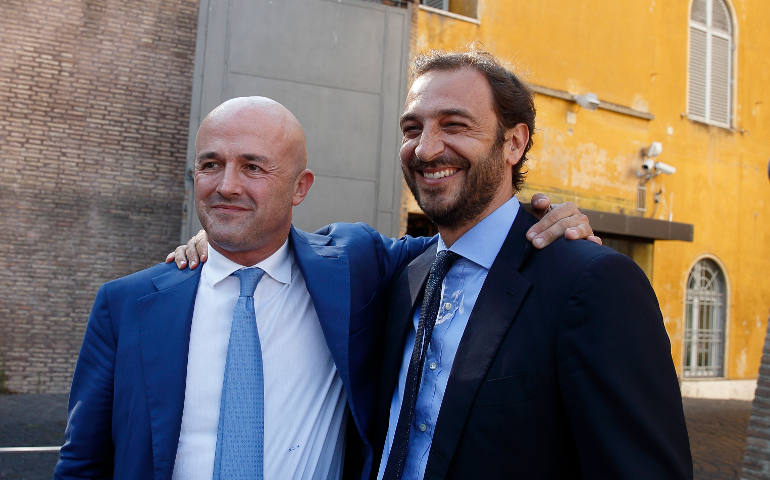 Italian journalists Gianluigi Nuzzi and Emiliano Fittipaldi embrace after leaving the final session of the so-called "Vatileaks" trial at the Vatican July 7. A Vatican court, citing freedom of the press, acquitted the two journalists who published confidential Vatican documents. (CNS photo/Paul Haring)