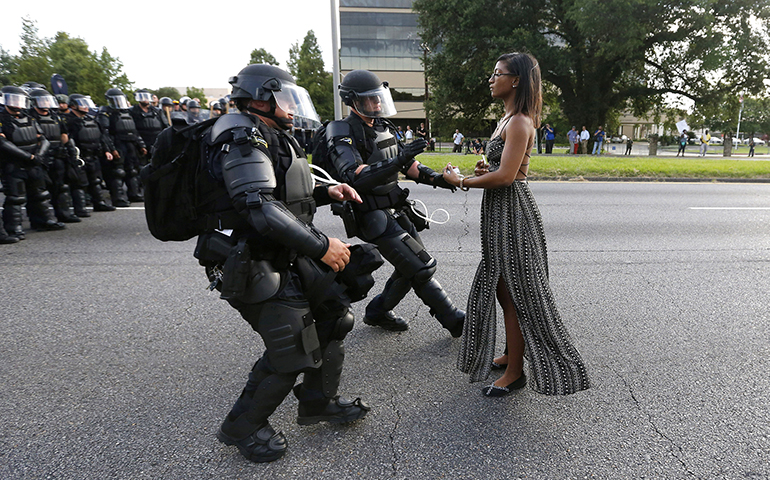 A protester is detained by Louisiana law enforcement near the headquarters of the Baton Rouge Police Department in Baton Rouge July 9. (CNS photo/Jonathan Bachman, Reuters)