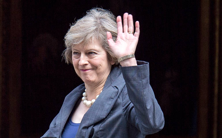 British Home Secretary Theresa May waves as she arrives July 12 to attend the last Cabinet meeting hosted by British Prime Minister David Cameron. (CNS photo/Will Oliver, EPA)